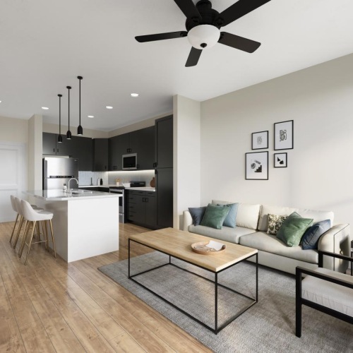 a living room with a wood floor, ceiling fan, and pendant lighting