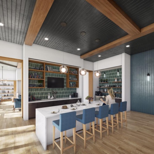 a well-lit room with a kitchen and a media area